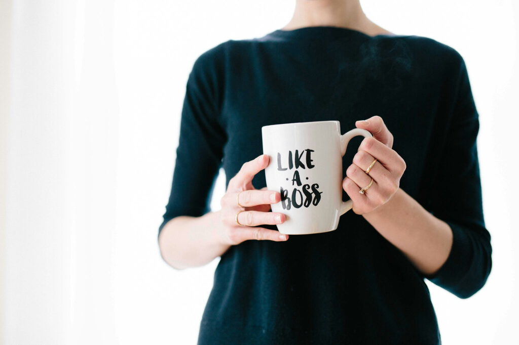 Woman holding a mug that says like a boss