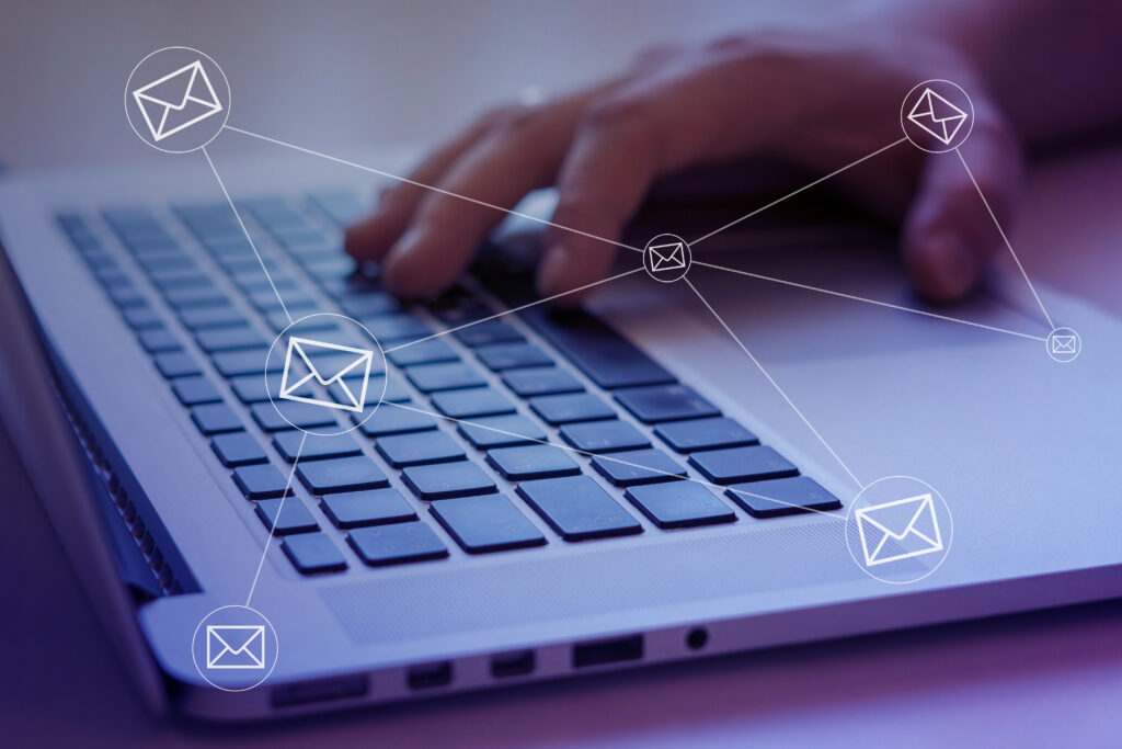 Marketing professional using a laptop overlayed with a networking graphic.